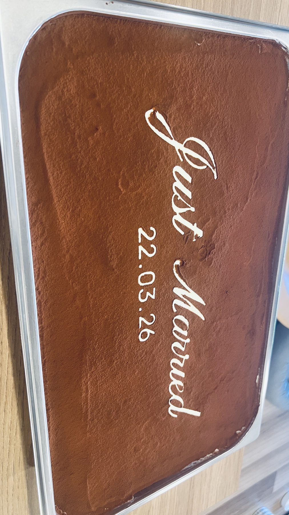 Classic tiramisu slab being prepared for catering